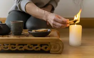 young woman relaxing home with tea candle