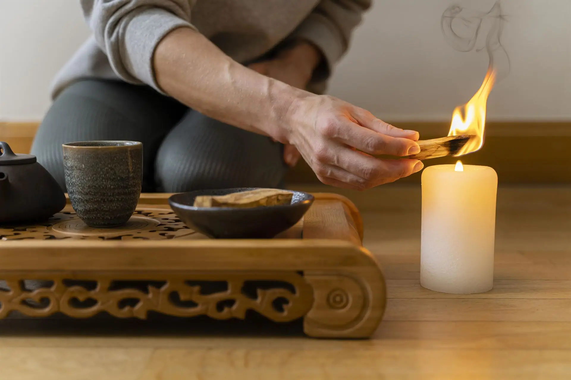 young woman relaxing home with tea candle